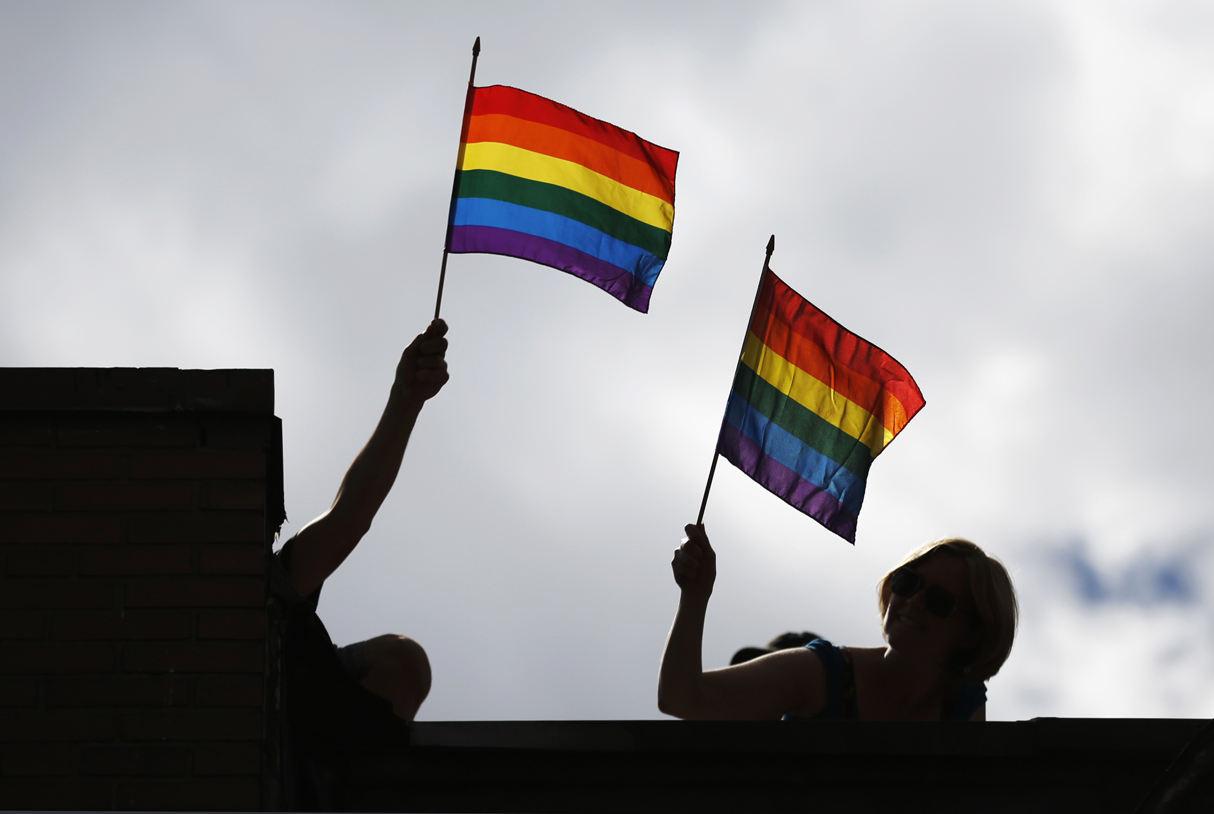 FILE PHOTO: People hold pride flags during the Gay Pride parade in Toronto July 1, 2012.    REUTERS/Mark Blinch